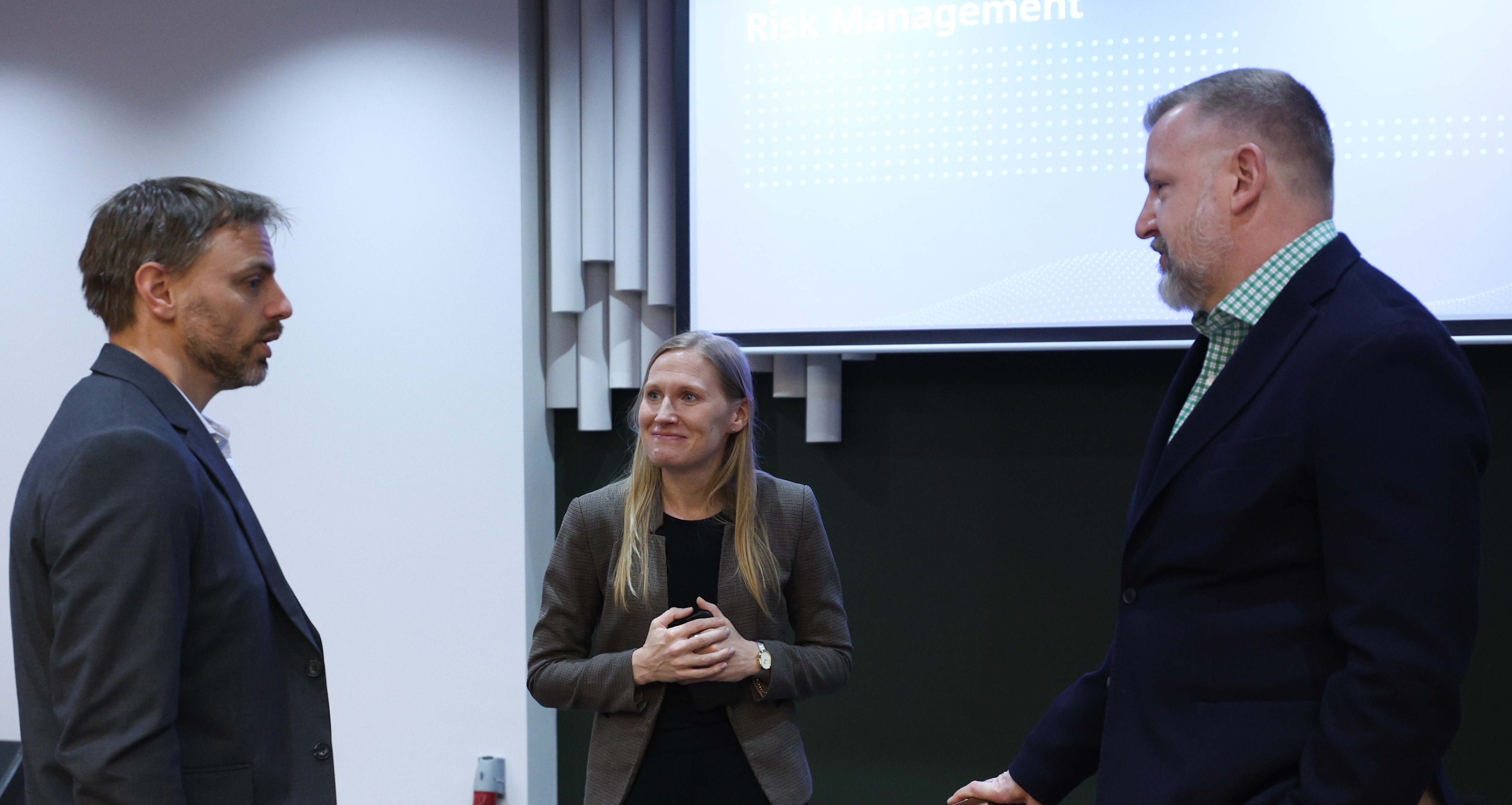 3 experts are communicating with each other standing