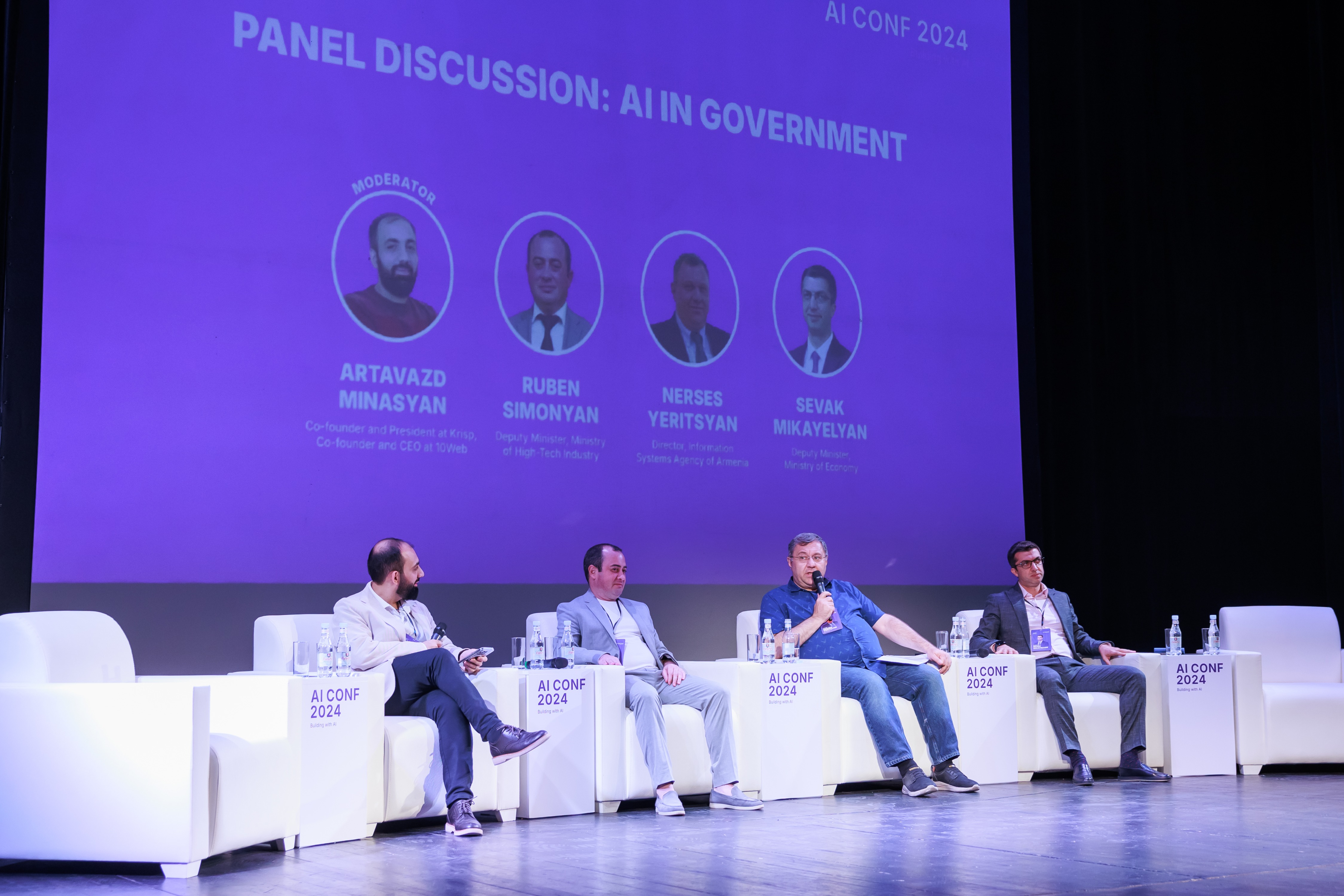 Three speakers in a panel discussion at AIconf 2024, including ISAA Director Nerses Yeritsyan, Deputy Minister of High-Tech Industry Ruben Simonyan, and Deputy Minister of Economy Sevak Mikayelyan, discussing the role of AI in improving government process